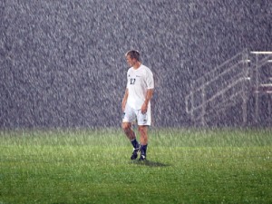lonely-player-in-rain lonely socer player in the rain
